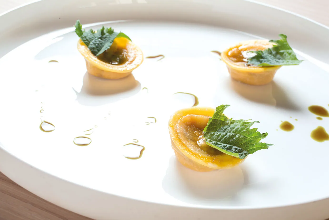 Ravioli di zucca, testina di maiale, prugne fermentate e amaro del Cadore